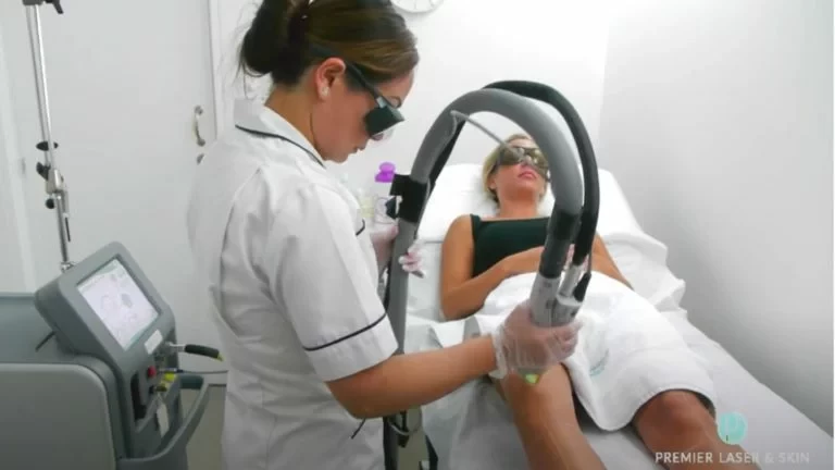 woman having laser hair removal on leg at a clinic